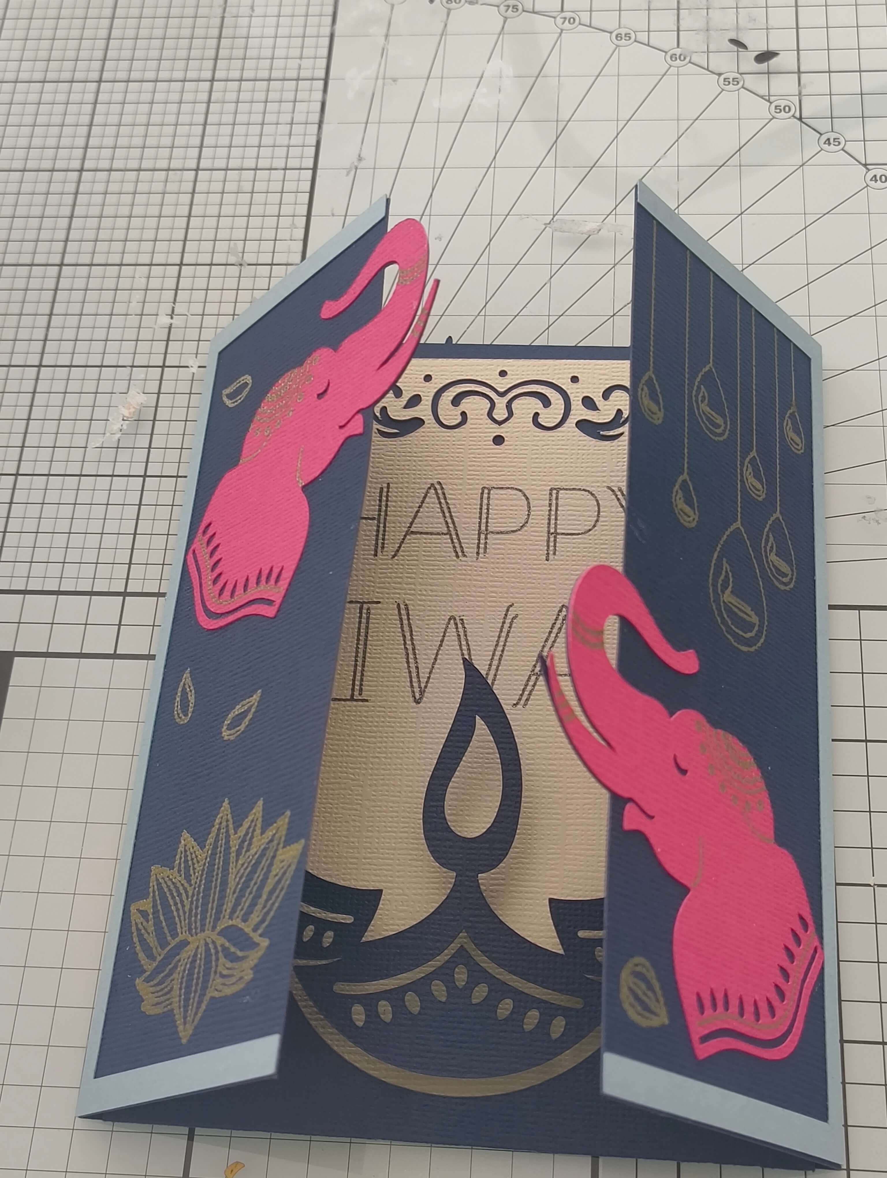 Handmade navy and gold Diwali card featuring pink elephant decorations and intricate design elements.