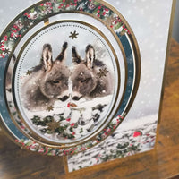 Handmade donkey Christmas card featuring two donkeys in a snowy scene with gold foiling and festive design.