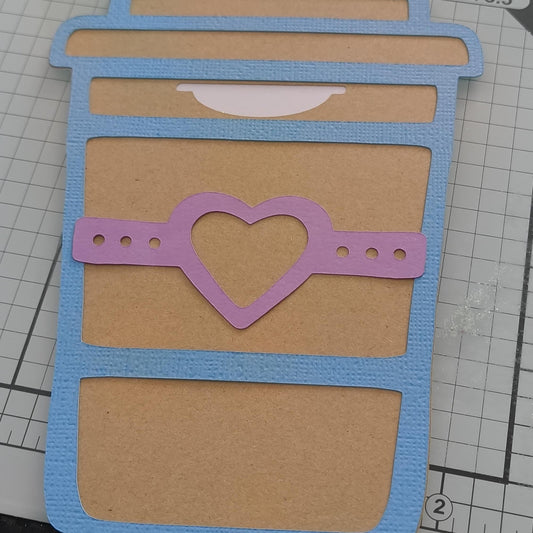 Handmade gift card holder shaped like a coffee cup, decorated with a blue border and a pink heart band.