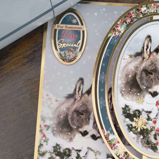 Handmade donkey Christmas card featuring a snowy scene and gold foiling for someone very special.