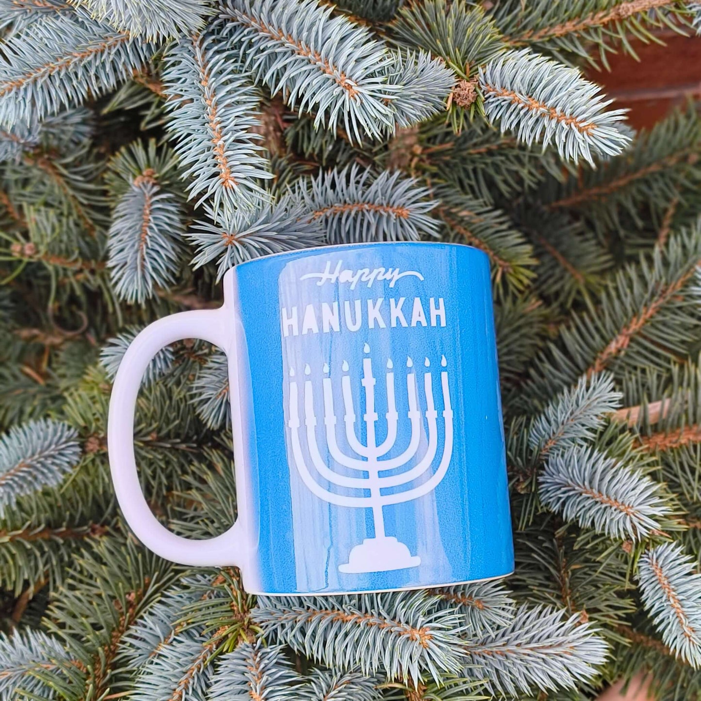 Happy Hanukkah mug featuring a menorah design, ideal for celebrating the Festival of Lights.