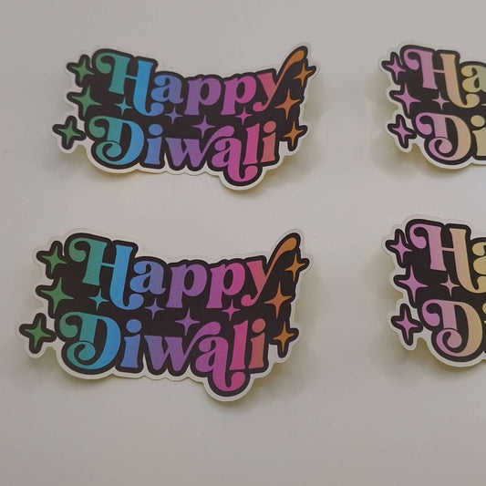 Close-up of two “Happy Diwali” stickers with bold rainbow lettering and star details on a white background.