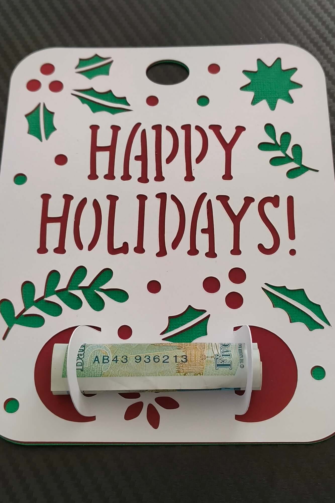 Handmade Happy Holidays money gift card holder with rolled banknote.