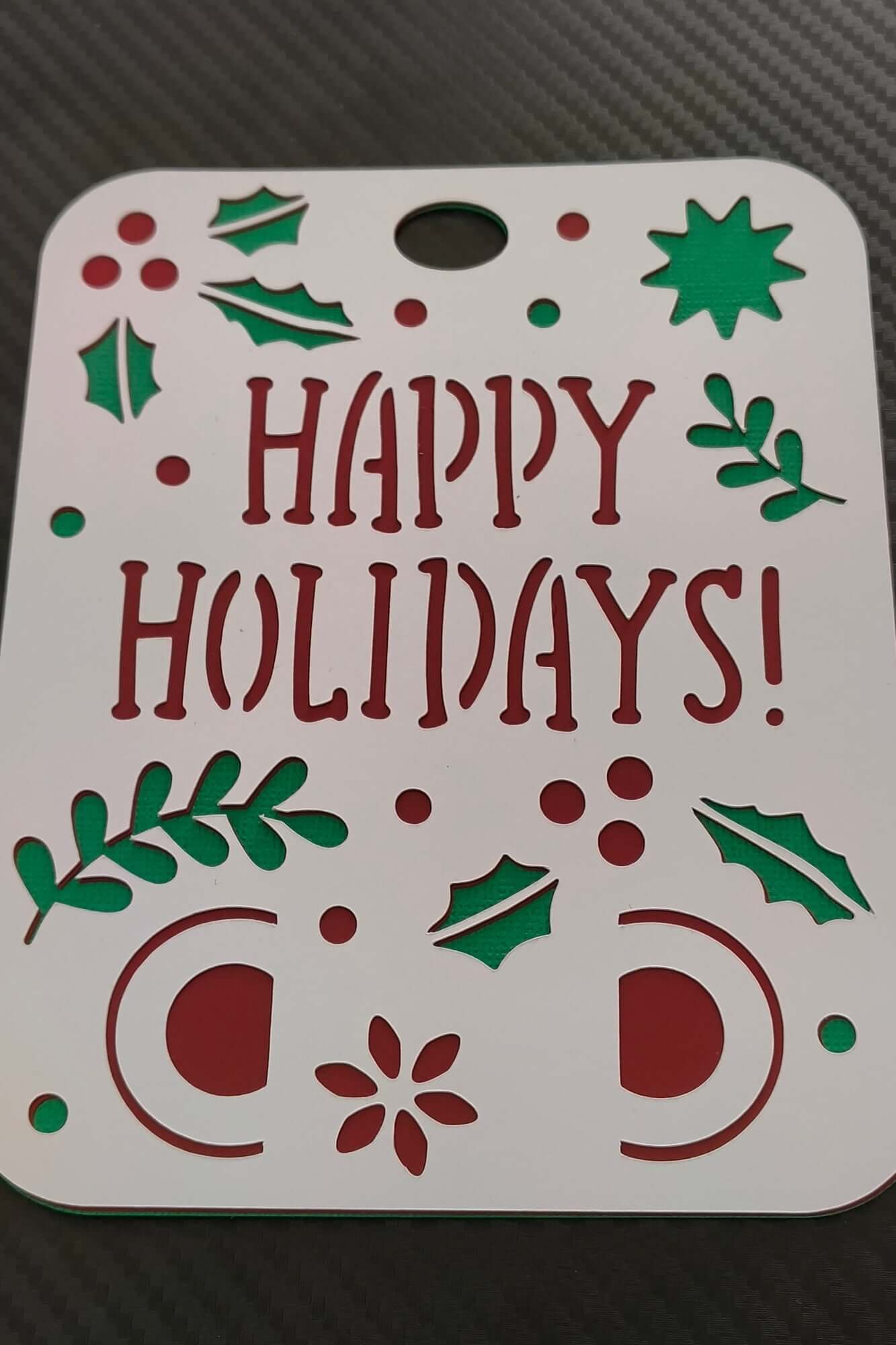 Handmade Happy Holidays money holder card with festive cut-out design in red and green.