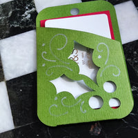Green and red Christmas gift card holder with holly design, perfect for presenting gift cards during the holidays.