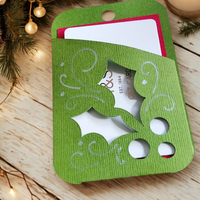 Holly gift card holder in green with cutouts, perfect for presenting Christmas gifts.