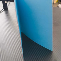 18th birthday card with bold, layered design, showcasing bright blue interior on a textured black surface.