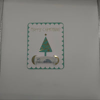 Inside of handmade Christmas card featuring green glitter tree money holder with space for a banknote gift.