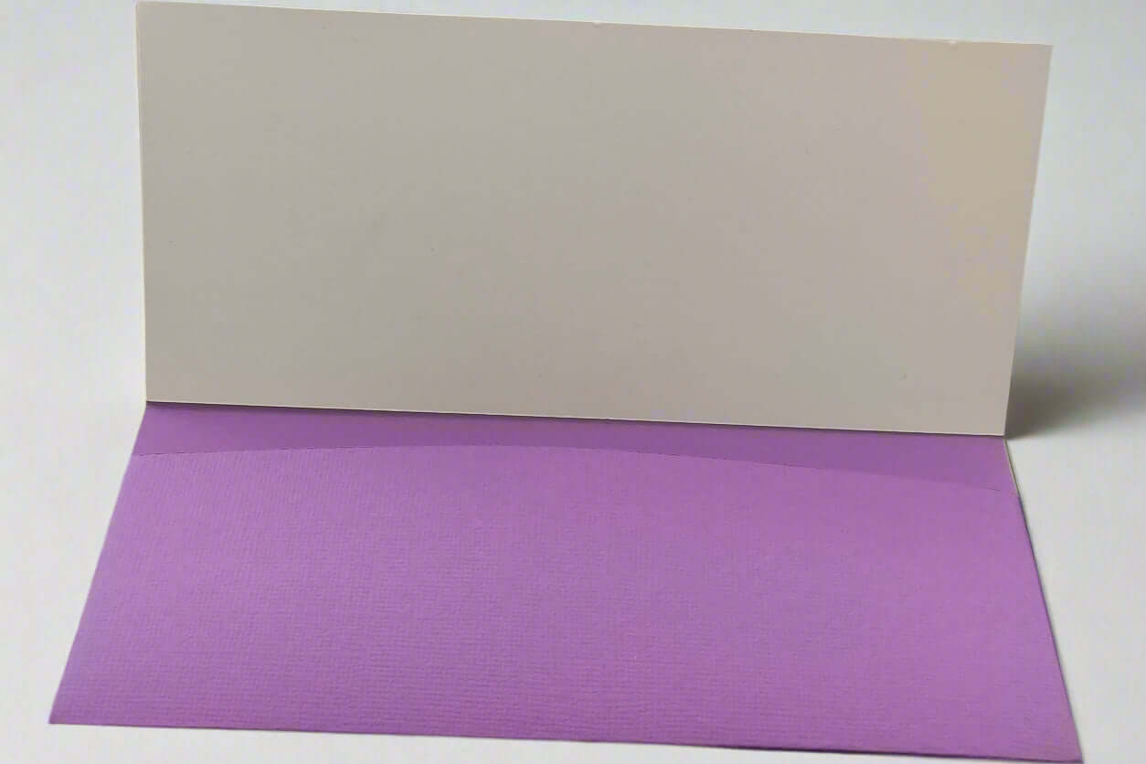 Inside view of a handmade purple money holder with a blank white insert, made from textured cardstock and displayed on a clean white background.