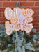 Detailed view of a gold and white “Go Jesus It’s Your Birthday” party decoration with sticks for display.