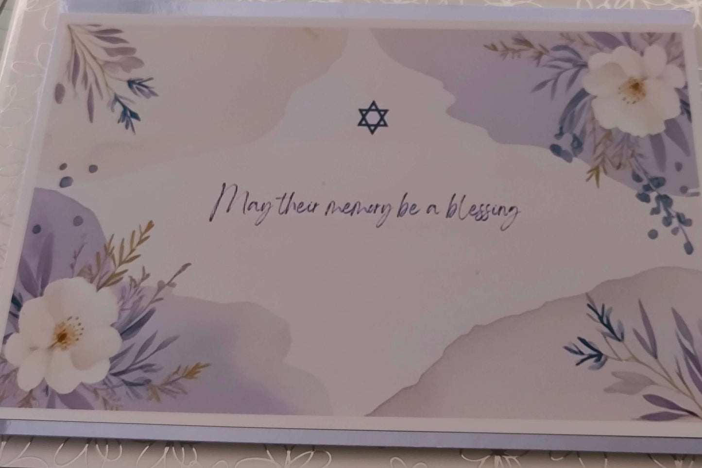 Jewish bereavement card with Star of David and floral design, featuring the message 'May their memory be a blessing' in handwritten script