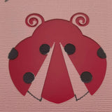 Close-up detail of a handmade red ladybird embellishment on pink textured cardstock, part of a greeting card design ideal for birthdays or well wishes.
