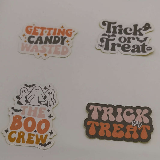 Fun loose Halloween stickers including “The Boo Crew”, “Trick or Treat”, candy-themed sayings, and ghost illustrations on a plain background.