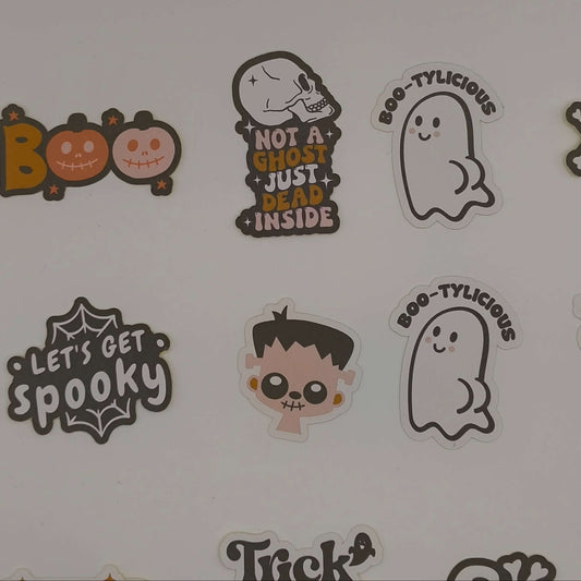 Selection of loose Halloween stickers with “Boo”, skull head design, “Let’s Get Spooky”, Frankenstein, and “Boo-tylicious” ghost characters.
