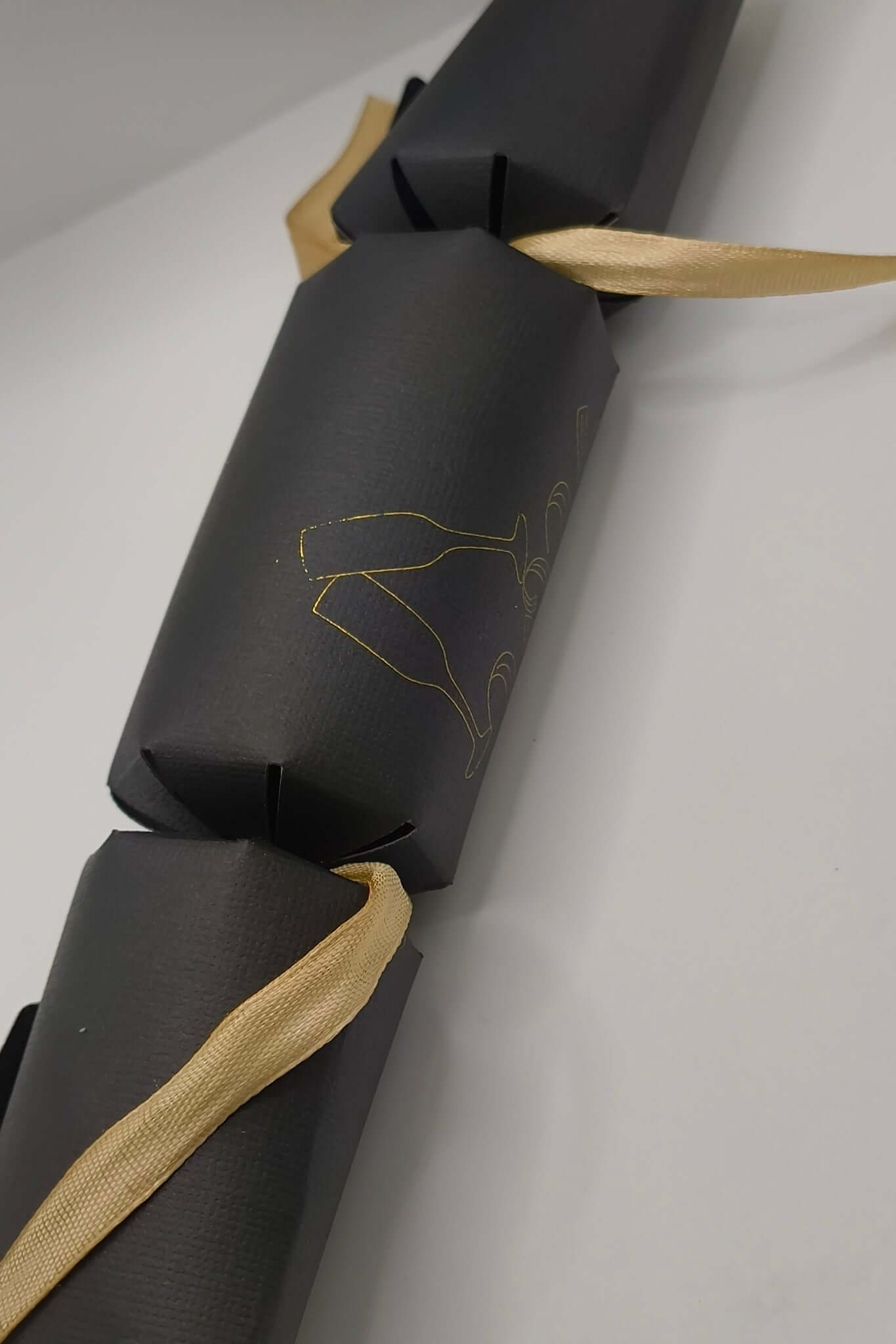 Personalised New Year cracker in black featuring gold design and ribbon, perfect for 2026 party decoration.