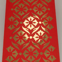 Close-up of luxury red envelope with gold foil cut-out floral pattern