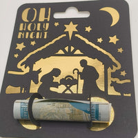 Close-up of Oh Holy Night nativity money holder card with gold foiled design and rolled note.
