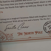 Close-up of personalised Santa letter featuring Santa Claus signature and North Pole stamp for a festive keepsake.