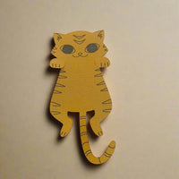Handmade orange cat bookmark made from textured cardstock, viewed from a top-down angle on a cream background.