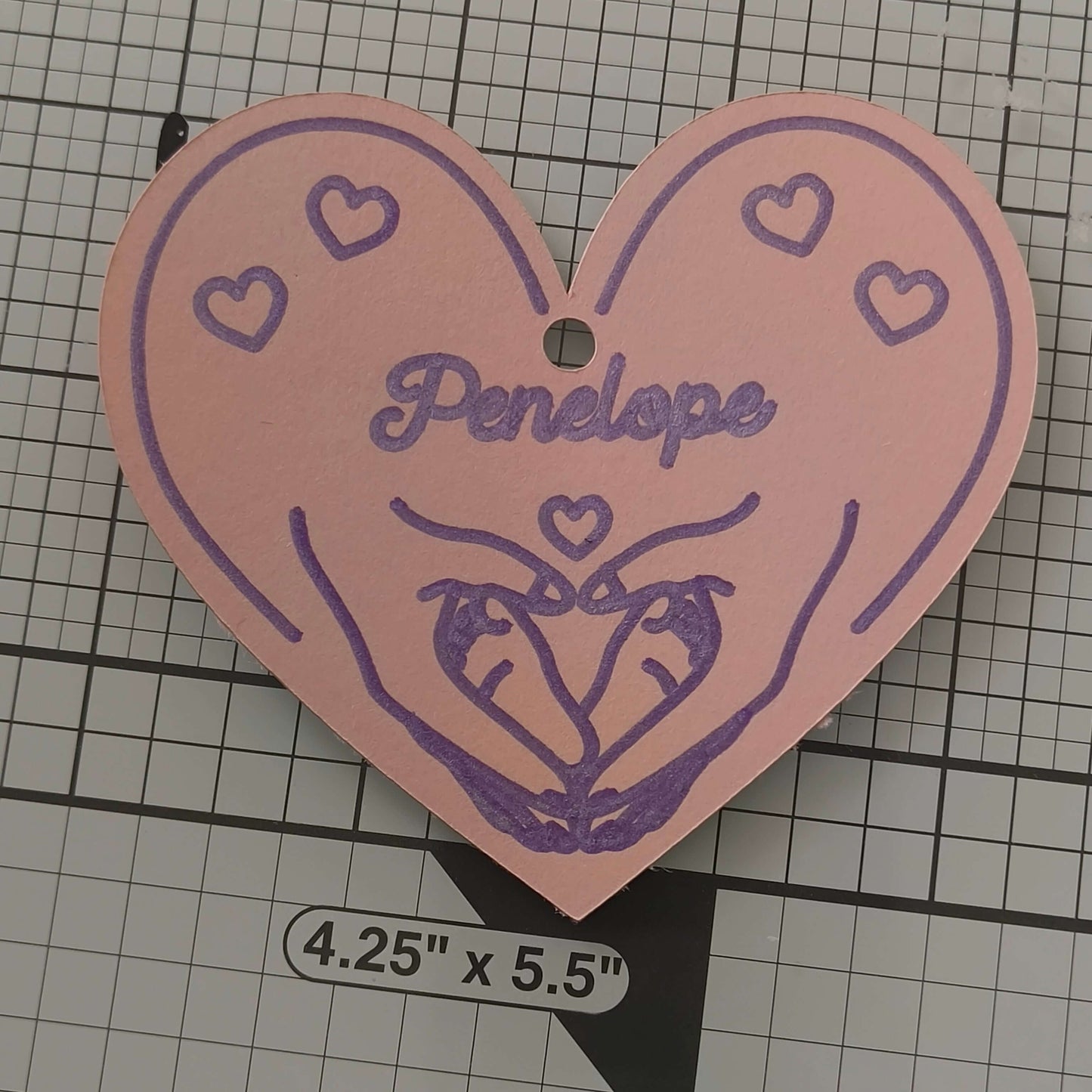 Personalised heart gift tag featuring hands and hearts, named 'Penelope', perfect for baby gifts.