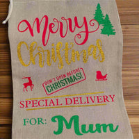 Personalised Christmas gift sack for Mum – hessian fabric with gold glitter “Christmas”, red festive icons, green vinyl name and trees, special delivery holiday design.