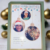 Personalised Christmas photo card – front angle – custom festive card with family photo baubles and green border.