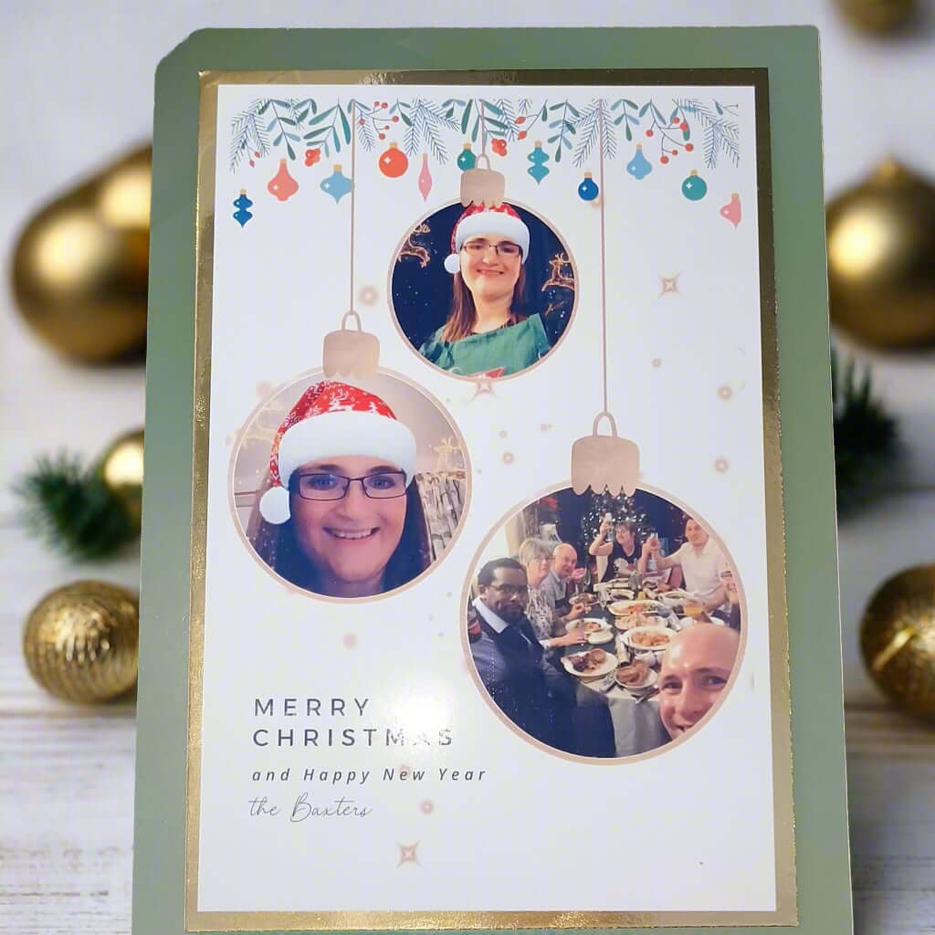 Personalised Christmas photo card – front angle – custom festive card with family photo baubles and green border.