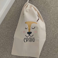 Personalised reindeer gift sack featuring a smiling reindeer face and the name 'Craig' in bold letters.