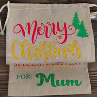 Personalised Merry Christmas gift sack for Mum – gold glitter text with red and green vinyl on rustic hessian fabric, festive tree design, perfect for holiday gifting.

