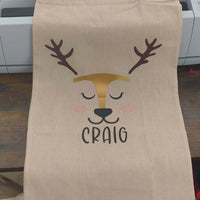 Personalised reindeer gift sack featuring the name 'Craig' and adorable reindeer face design