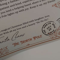 Close-up of a personalised Santa letter with a North Pole postmark, perfect for Christmas keepsake.