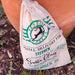 Personalised Santa sack with green Reindeer Express design, drawstring closure, and “Special Delivery” text, placed outdoors by a plant pot.
