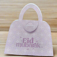 Elegant pink Eid Mubarak money holder shaped like a handbag, with floral pattern detail, perfect for gifting money during Eid celebrations.