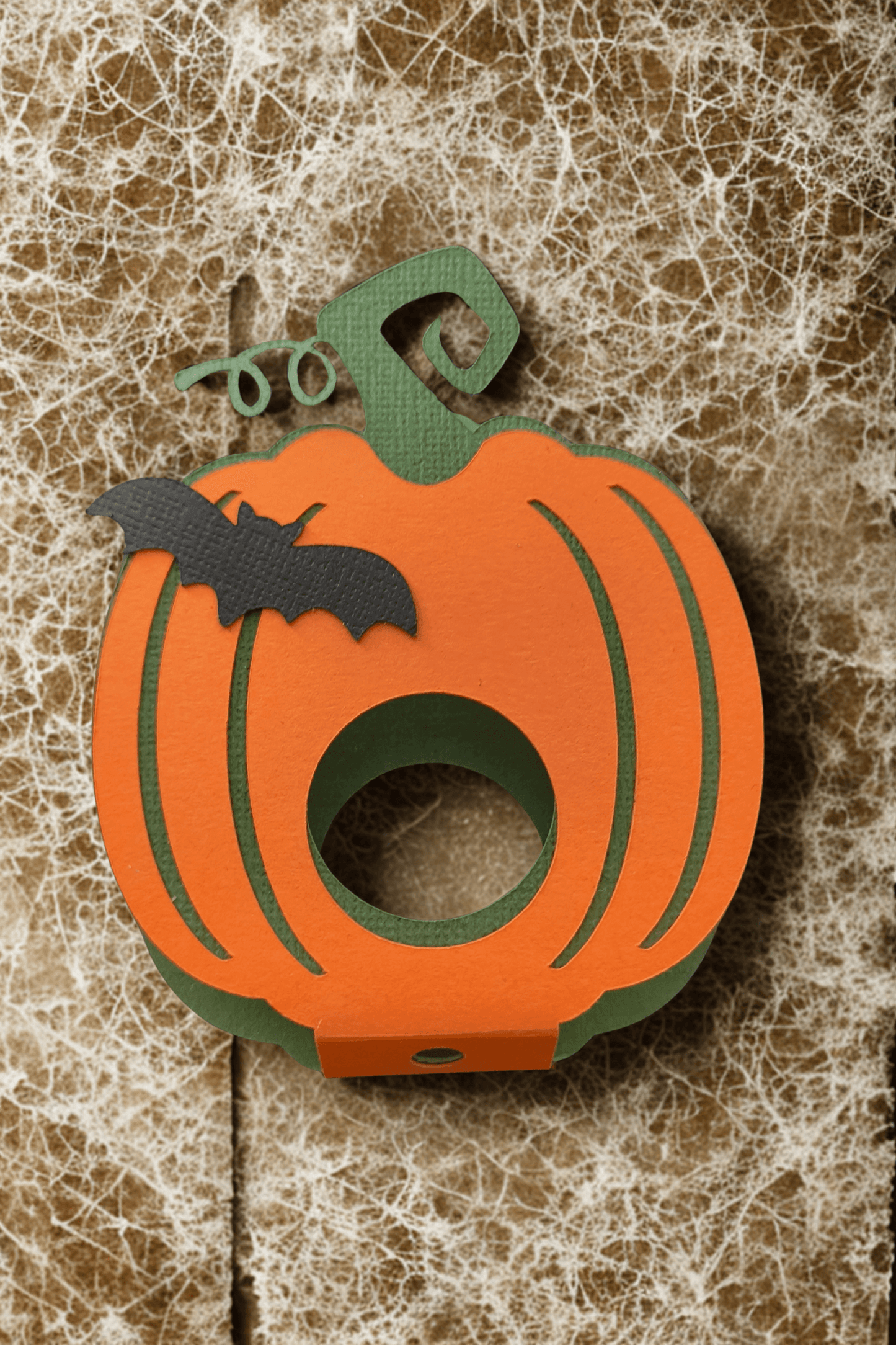 Cute Halloween pumpkin lollipop holder with bat design, perfect for kids' treats and parties.