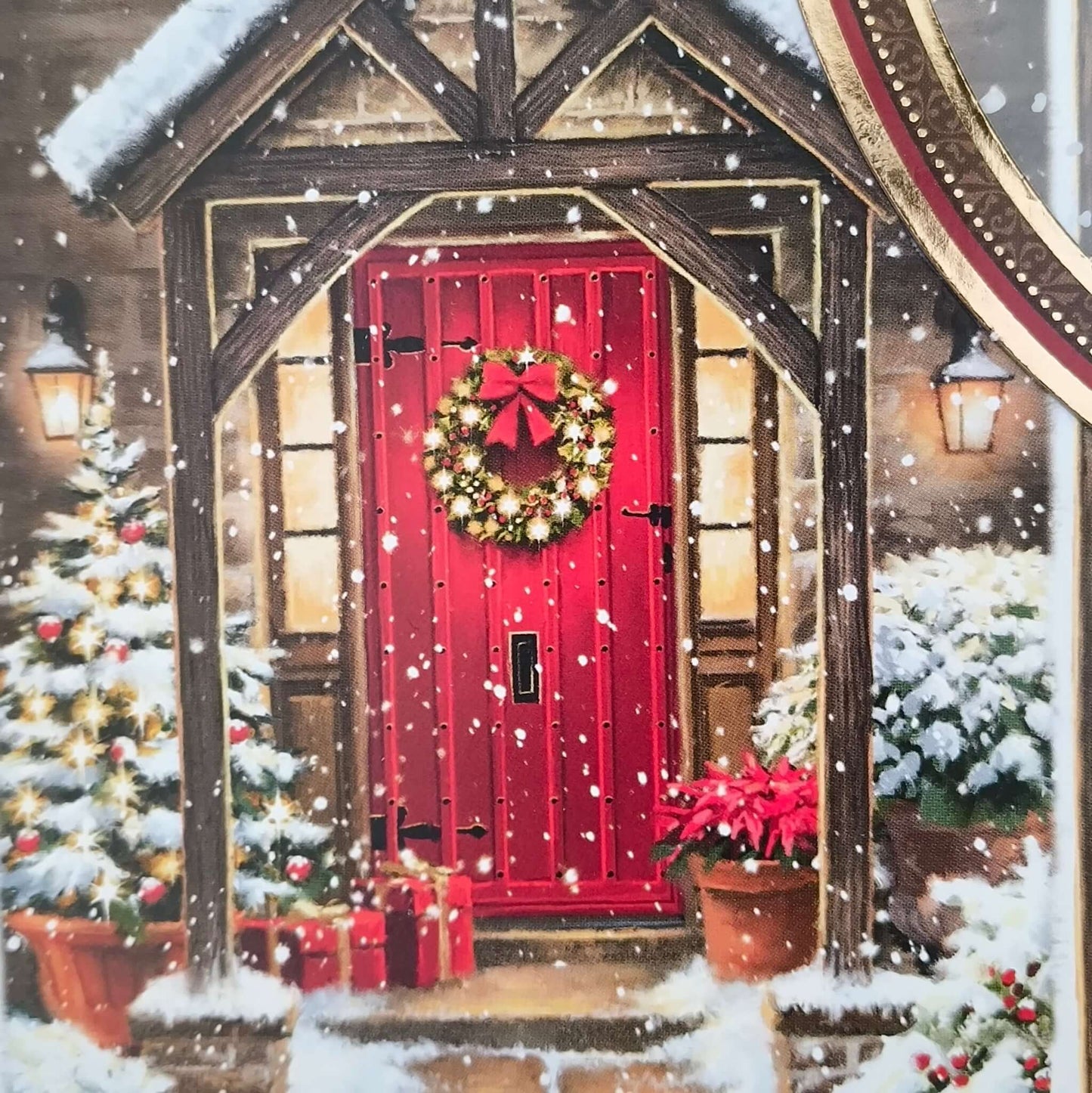 Detailed view of festive red door on handmade Christmas card with snow, wreath, poinsettias, and Christmas tree.