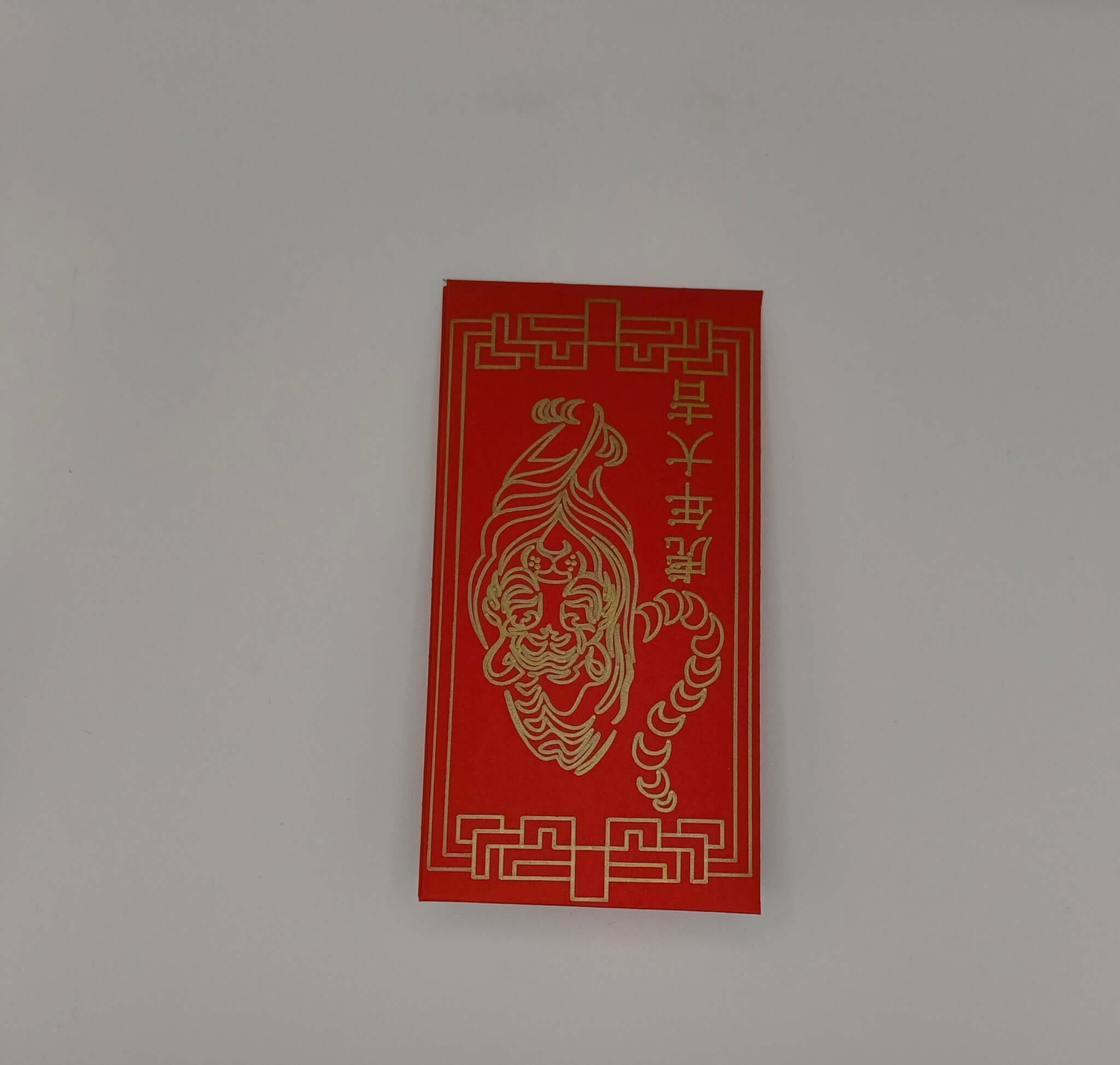 ed Chinese New Year envelope with gold pen tiger face design and decorative border.