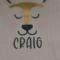 Personalised reindeer gift sack featuring the name 'Craig' in bold black vinyl and gold foil accents.