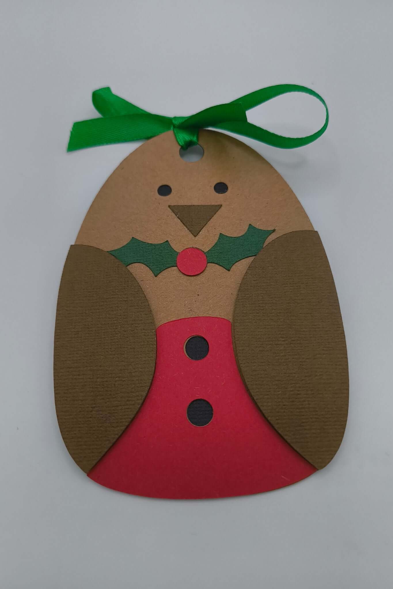 Handmade robin Christmas gift tag with green ribbon, ready to attach to presents.
