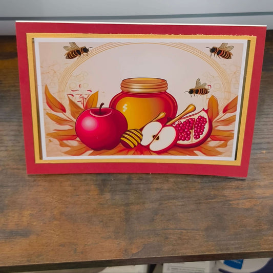Vibrant Rosh Hashanah card featuring apples, honey, and pomegranates in a festive design.