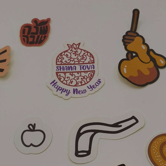 Rosh Hashanah stickers with a decorative pomegranate design, honey dipper illustration, and Shana Tova text.