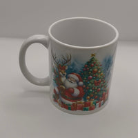 White ceramic mug with Santa Claus and Christmas tree design, displayed on plain background