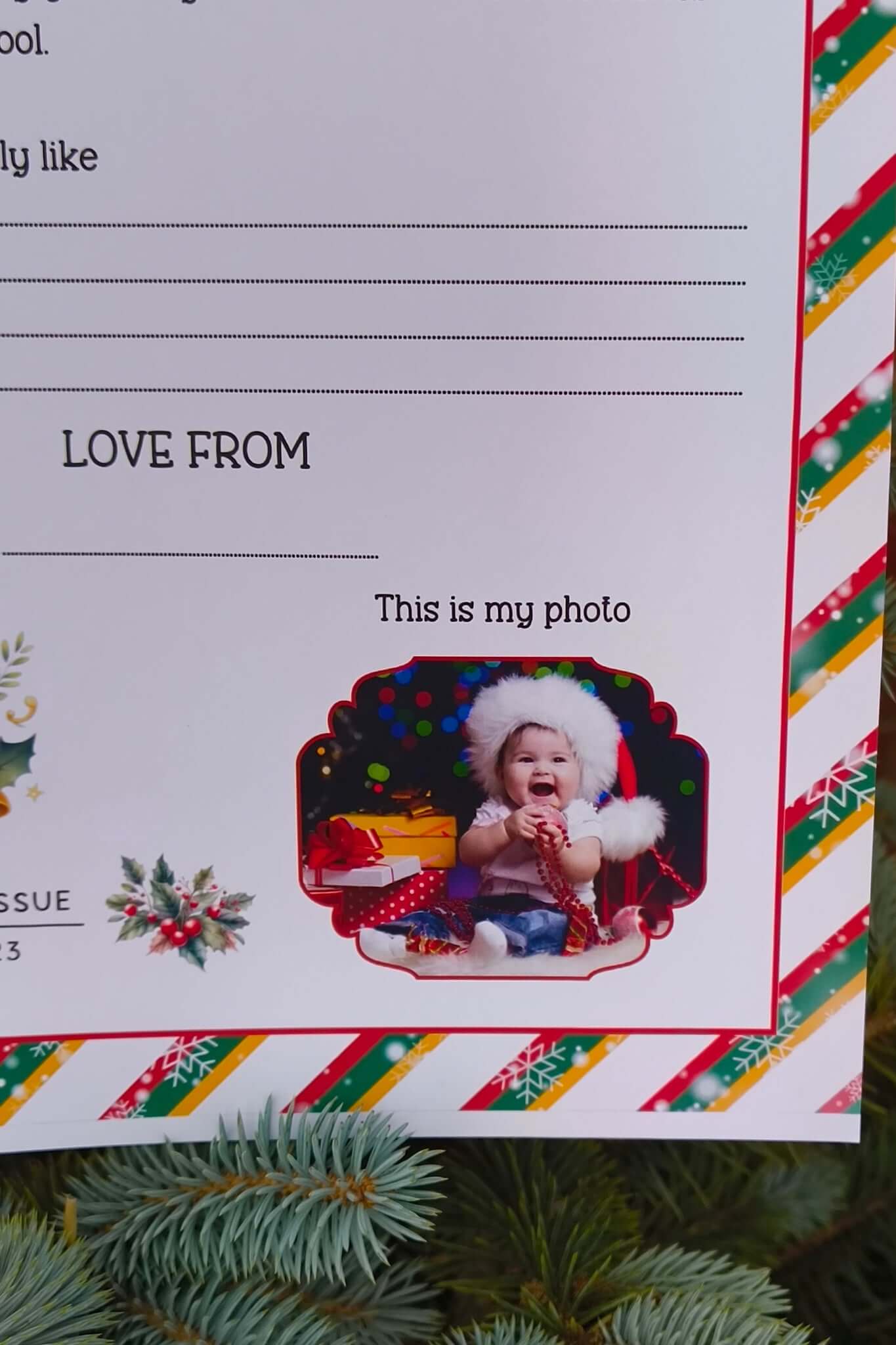 Close-up of Official Santa Claus letter showing photo section for child’s picture, festive design with holly, bell illustration, and colourful candy stripe border.