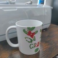 Personalised Christmas mug featuring poinsettia and holly design, perfect for festive drinks.