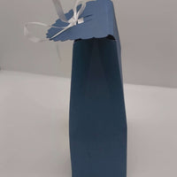 Side view of navy Ganesh gift box with scalloped lid and ribbon tie, showing handmade cardstock construction for Diwali or wedding favours.