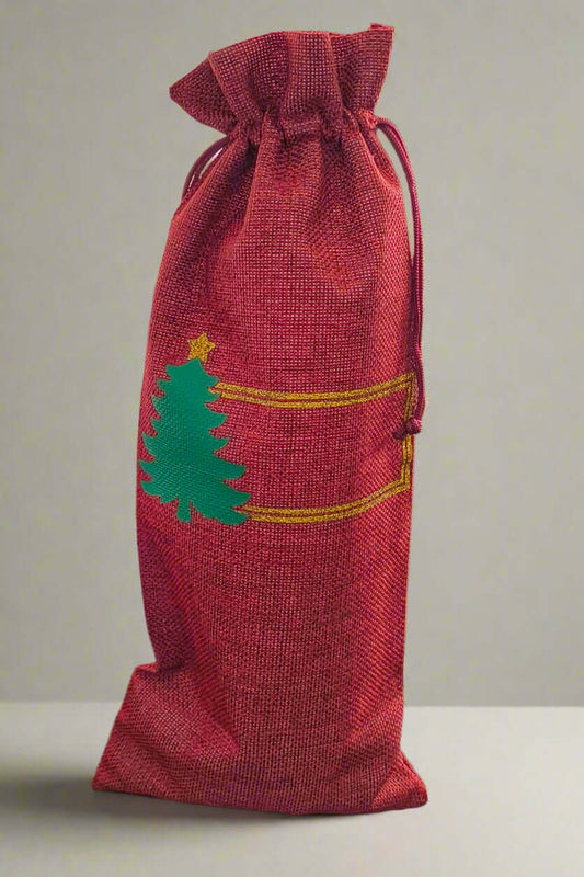 Personalised Christmas wine bottle bag in red hessian with green tree design, perfect for festive gifting.