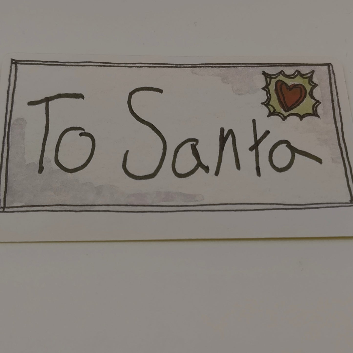 Single To Santa Christmas sticker with hand-drawn lettering and holly stamp