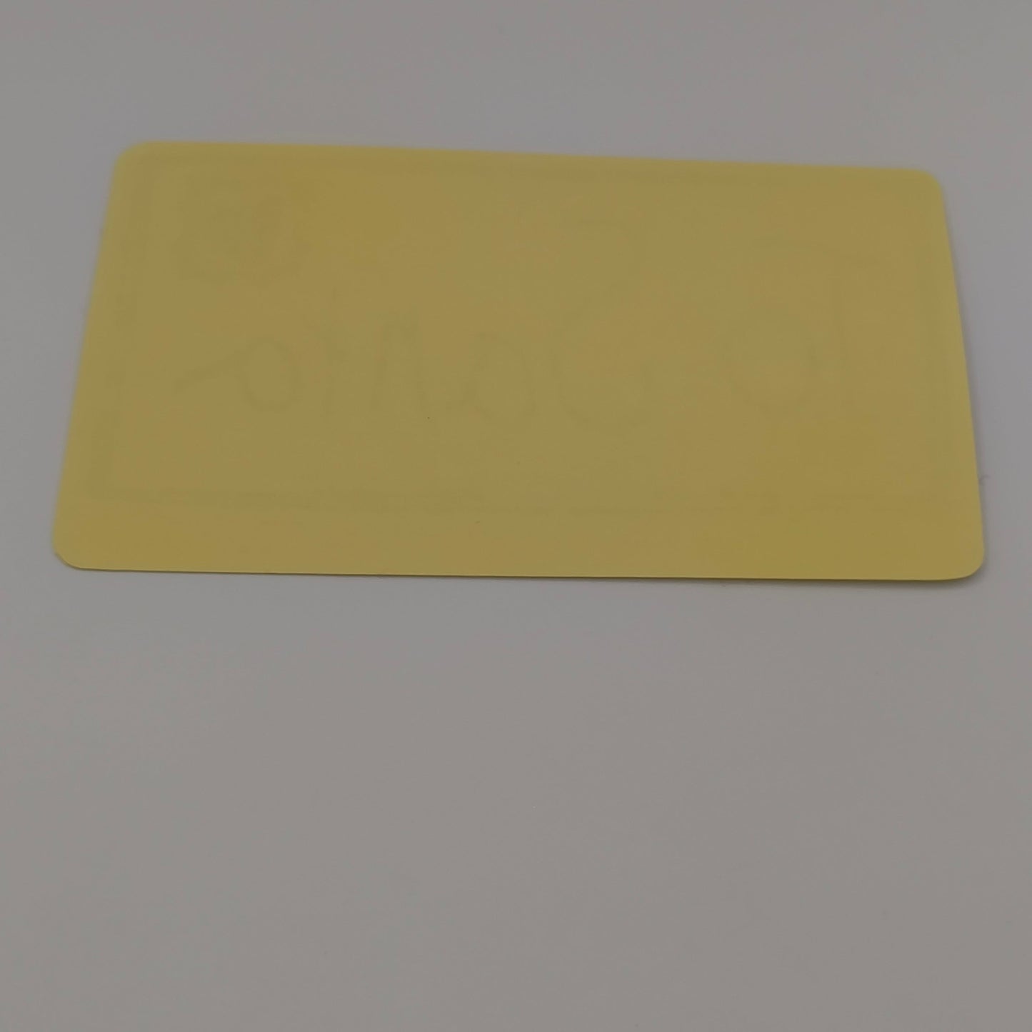 Back view of To Santa Christmas sticker showing plain yellow adhesive backing