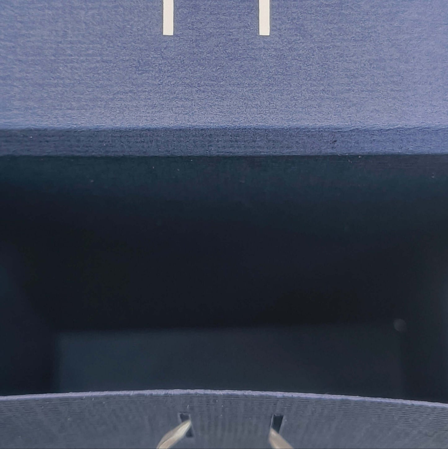 Top view inside navy Ganesh gift box showing slots for ribbon closure, handmade for Hindu celebrations and festive gifting.