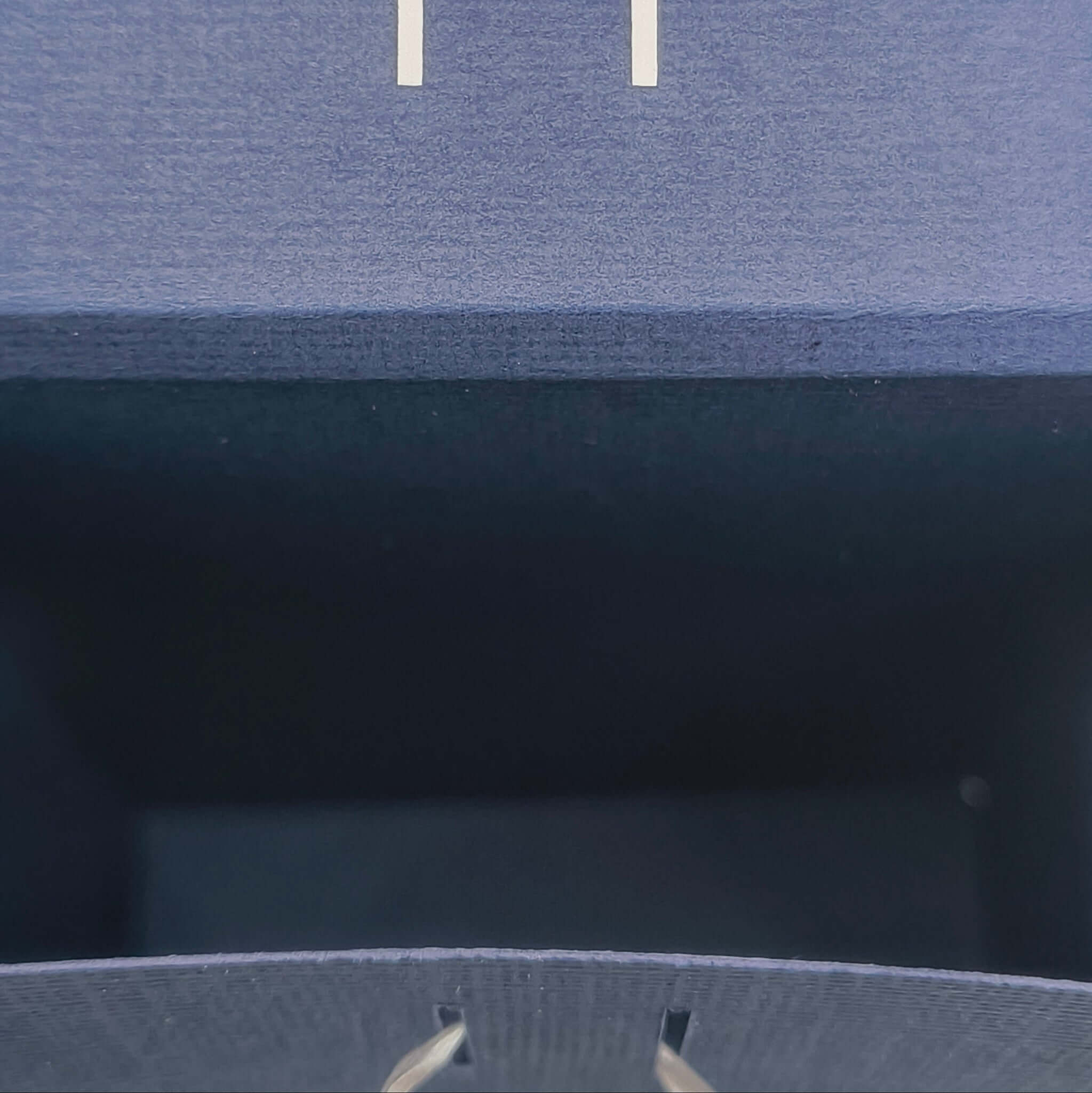 Top view inside navy Ganesh gift box showing slots for ribbon closure, handmade for Hindu celebrations and festive gifting.