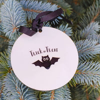 Trick or Treat bat design Halloween bauble, black ribbon hanging decoration for seasonal decor.